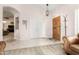 Open concept living room with tiled entryway, view of front door, and coat rack at 20386 E Bronco Dr, Queen Creek, AZ 85142