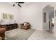 Open concept living room with an archway, vaulted ceiling, and plush chair at 20386 E Bronco Dr, Queen Creek, AZ 85142