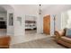 Open concept living room with view of a bedroom, tiled entryway, and front door at 20386 E Bronco Dr, Queen Creek, AZ 85142