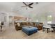 Open-concept living room showcasing a large sectional sofa, vaulted ceiling and carpet at 20386 E Bronco Dr, Queen Creek, AZ 85142