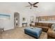 Comfortable living room featuring a large sectional sofa, vaulted ceiling and carpet at 20386 E Bronco Dr, Queen Creek, AZ 85142