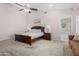 This carpeted main bedroom with ceiling fan has an attached bathroom with a tub at 20386 E Bronco Dr, Queen Creek, AZ 85142
