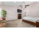 This carpeted main bedroom has a ceiling fan and a closet for storage at 20386 E Bronco Dr, Queen Creek, AZ 85142