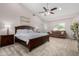 This main bedroom features a ceiling fan, art work, sitting area and plenty of light at 20386 E Bronco Dr, Queen Creek, AZ 85142