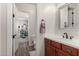 Half bath with wood look tile floors and view of the secondary bedroom at 20421 W Legend Trl, Buckeye, AZ 85396
