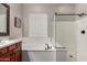 Bathroom showcasing a soaking tub, shower, and wood-look tile flooring, offering a spa-like experience at 20421 W Legend Trl, Buckeye, AZ 85396