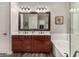 Bright bathroom featuring double vanity, soaking tub, and wood-look tile flooring, creating a relaxing space at 20421 W Legend Trl, Buckeye, AZ 85396