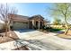 Inviting single-story home boasting a stone facade, two-car garage, and neatly landscaped front yard at 20421 W Legend Trl, Buckeye, AZ 85396