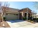 Attractive single-story home featuring a stone accent facade and a well-manicured front yard at 20421 W Legend Trl, Buckeye, AZ 85396