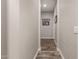 Neutral hallway featuring stylish wall decor and wood-look tile flooring, creating a welcoming atmosphere at 20421 W Legend Trl, Buckeye, AZ 85396