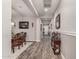 Bright hallway with wood-style tile flooring, neutral paint, and stylish decor at 20421 W Legend Trl, Buckeye, AZ 85396
