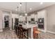 Bright kitchen with stainless steel appliances, granite countertops, and center island with seating at 20421 W Legend Trl, Buckeye, AZ 85396