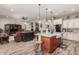 Kitchen island with granite countertops, seating, stainless appliances and hardwood style flooring at 20421 W Legend Trl, Buckeye, AZ 85396