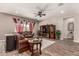 Comfortable living room with wood-style tile flooring, ceiling fan, and stylish furnishings at 20421 W Legend Trl, Buckeye, AZ 85396
