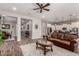 Open concept living room featuring wood-style tile flooring, neutral paint, and updated kitchen at 20421 W Legend Trl, Buckeye, AZ 85396