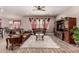 Spacious living room featuring wood-style tile flooring and comfortable leather seating at 20421 W Legend Trl, Buckeye, AZ 85396