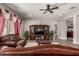 Cozy living room with wood-style tile flooring, ceiling fan, and decorative furnishings at 20421 W Legend Trl, Buckeye, AZ 85396