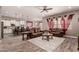 Inviting living room featuring wood-style tile flooring and open access to the kitchen at 20421 W Legend Trl, Buckeye, AZ 85396