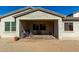 Cozy covered patio with brick flooring, perfect for outdoor relaxing and entertaining at 20421 W Legend Trl, Buckeye, AZ 85396