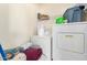 Functional laundry room with washer, dryer, and storage space at 21876 W Mohave St, Buckeye, AZ 85326