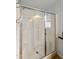 This bathroom features a walk in shower with sliding glass doors, white tiled walls and a shower head at 2263 N Trekell Rd # 175, Casa Grande, AZ 85122