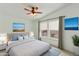 This staged bedroom has carpet, ceiling fan, two windows, curtain, plants and wall decor at 2263 N Trekell Rd # 175, Casa Grande, AZ 85122