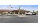 View of the building exterior, showing mature landscaping, parking and the flags at 2263 N Trekell Rd # 175, Casa Grande, AZ 85122