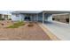 Charming single-story home with light blue siding, carport, and neatly landscaped front yard at 2263 N Trekell Rd # 175, Casa Grande, AZ 85122