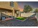 Exterior view of backyard featuring covered patio, grill, string lights, rock landscaping and grass at 2402 E 5Th St # 1455, Tempe, AZ 85288