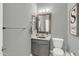 Well-lit half bathroom with gray vanity and updated fixtures at 2402 E 5Th St # 1455, Tempe, AZ 85288