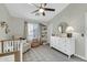 This airy Bedroom features a chair, dresser, crib and sunny window views at 2402 E 5Th St # 1455, Tempe, AZ 85288