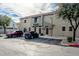 Townhome with a neutral color scheme, dark brown shutters, and well-maintained landscaping at 2402 E 5Th St # 1455, Tempe, AZ 85288