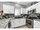 Kitchen with white cabinets, stainless steel appliances, and granite countertops at 2402 E 5Th St # 1455, Tempe, AZ 85288