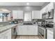 Modern kitchen featuring stainless steel appliances, granite countertops, and white cabinetry at 2402 E 5Th St # 1455, Tempe, AZ 85288