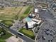 Detailed aerial of community, golf course, pool, parking, and shopping within a short walk at 2416 N Snead Dr, Mesa, AZ 85215