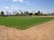 Well-maintained baseball field showcasing lush green grass and neatly groomed sand, perfect for sports and recreation at 2416 N Snead Dr, Mesa, AZ 85215