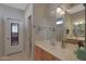 Bright bathroom with a large mirror, wood cabinets, and tile flooring at 2416 N Snead Dr, Mesa, AZ 85215