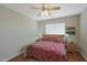 Cozy bedroom features a ceiling fan, a window with blinds, and a comfortable bed at 2416 N Snead Dr, Mesa, AZ 85215