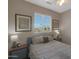 Bright bedroom featuring matching bedside tables, lamps, and framed artwork at 2416 N Snead Dr, Mesa, AZ 85215