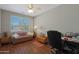 This bedroom features a cozy couch, wooden floors and a large window at 2416 N Snead Dr, Mesa, AZ 85215
