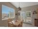 Dining area features a wood table set, bright natural light and sliding glass door to the backyard at 2416 N Snead Dr, Mesa, AZ 85215