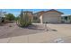 Charming single-story home with desert landscaping, covered porch, and two-car garage at 2416 N Snead Dr, Mesa, AZ 85215