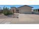 Lovely home with desert landscaping, a two-car garage, and a welcoming front patio with table and chairs at 2416 N Snead Dr, Mesa, AZ 85215