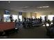 Well-equipped gym with modern exercise machines, large windows offering natural light and TVs for entertainment at 2416 N Snead Dr, Mesa, AZ 85215