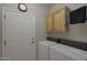 Convenient laundry area with washer, dryer, and overhead cabinets at 2416 N Snead Dr, Mesa, AZ 85215