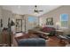 Comfortable living room features a ceiling fan, wood floors, and a large window for great light at 2416 N Snead Dr, Mesa, AZ 85215