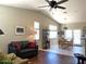 Open-concept living room with a ceiling fan, sofa, and dining area visible in background at 2416 N Snead Dr, Mesa, AZ 85215