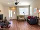 Comfortable living room features a ceiling fan, recliner, sofa, and laminate wood flooring at 2416 N Snead Dr, Mesa, AZ 85215