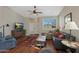 Comfortable living room features a ceiling fan, wood floors, and a large window for great light at 2416 N Snead Dr, Mesa, AZ 85215