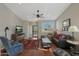 Cozy living room with a ceiling fan, hardwood floors, and large window for lots of natural light at 2416 N Snead Dr, Mesa, AZ 85215